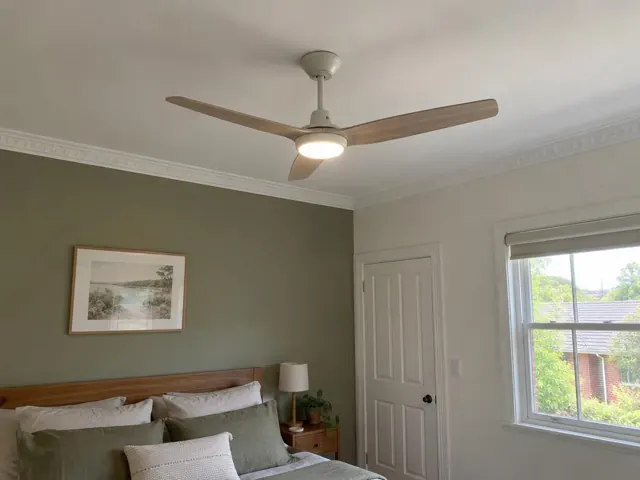 Ceiling fan installed on a bedroom ceiling with crown moulding, bed, window and door in Lambton